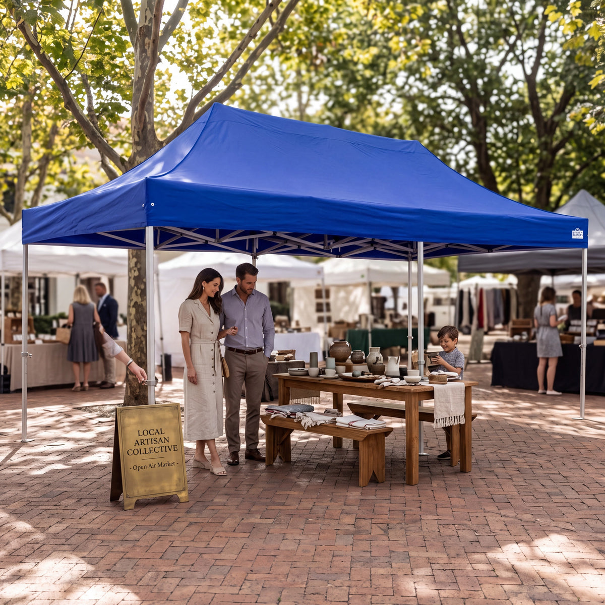 Army Stores heavy duty blue pop up canopy providing shade for a family at an outdoor market event